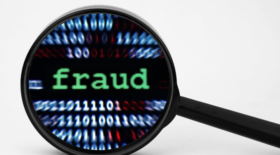 Magnifying glass with fraud text